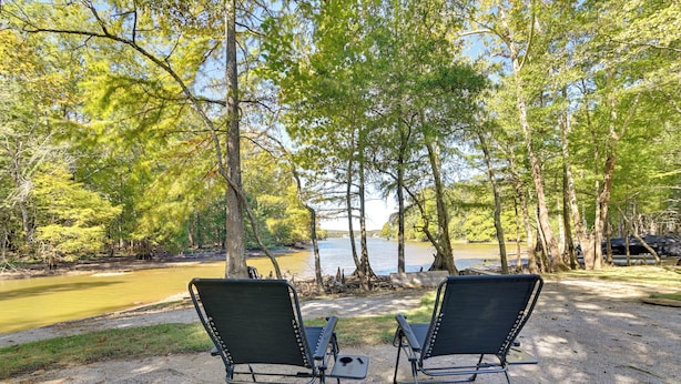 Two camping chairs facing a lake with trees in the background. - Private Hot Tub, Fire Pit! Pickwick Lake Escape (Cherokee)