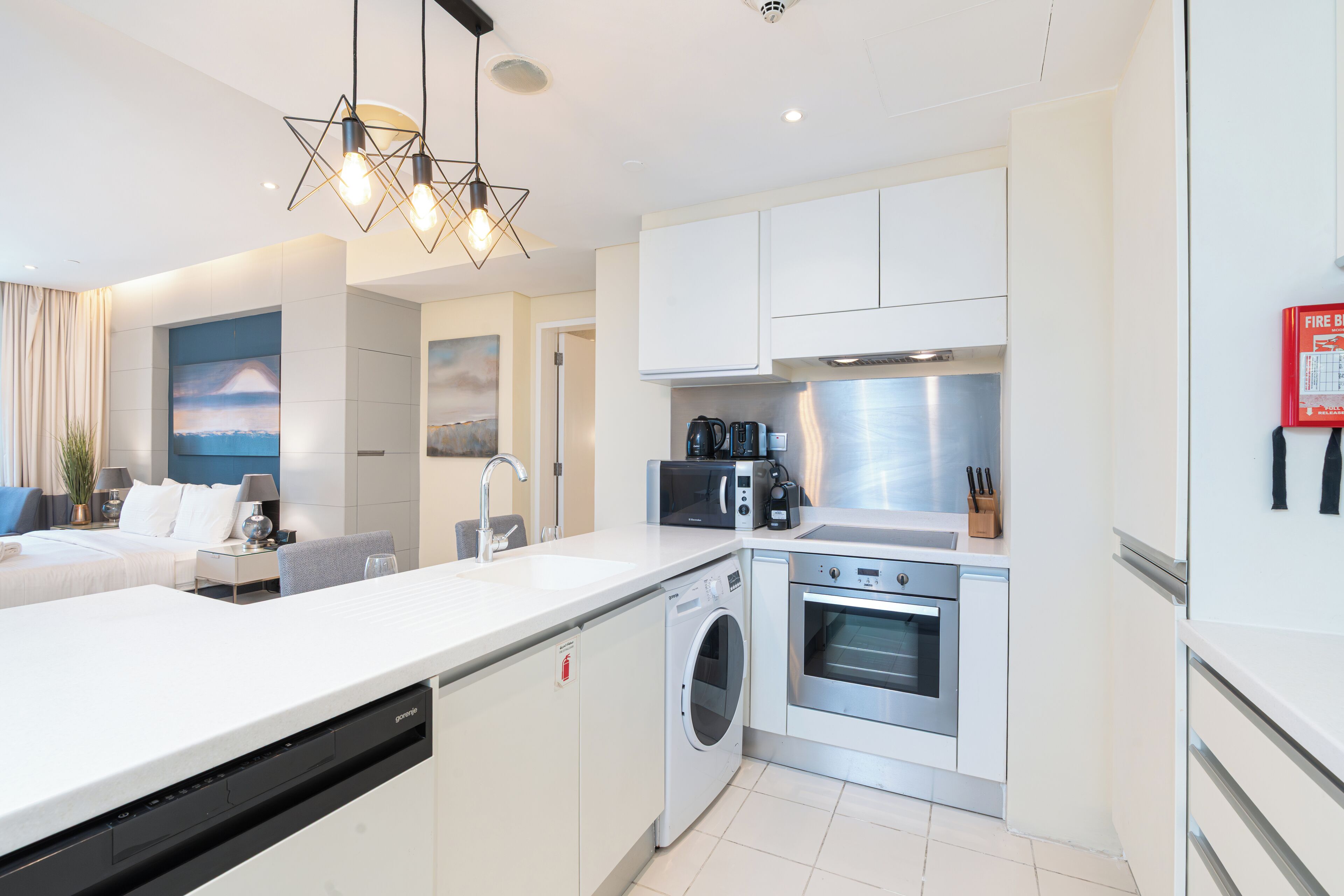 A modern kitchen with a dishwasher, oven, and microwave.