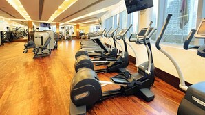 A gym with treadmills, elliptical machines, and weight machines. - PVH - Emaar Residences - Studio (Dubai)