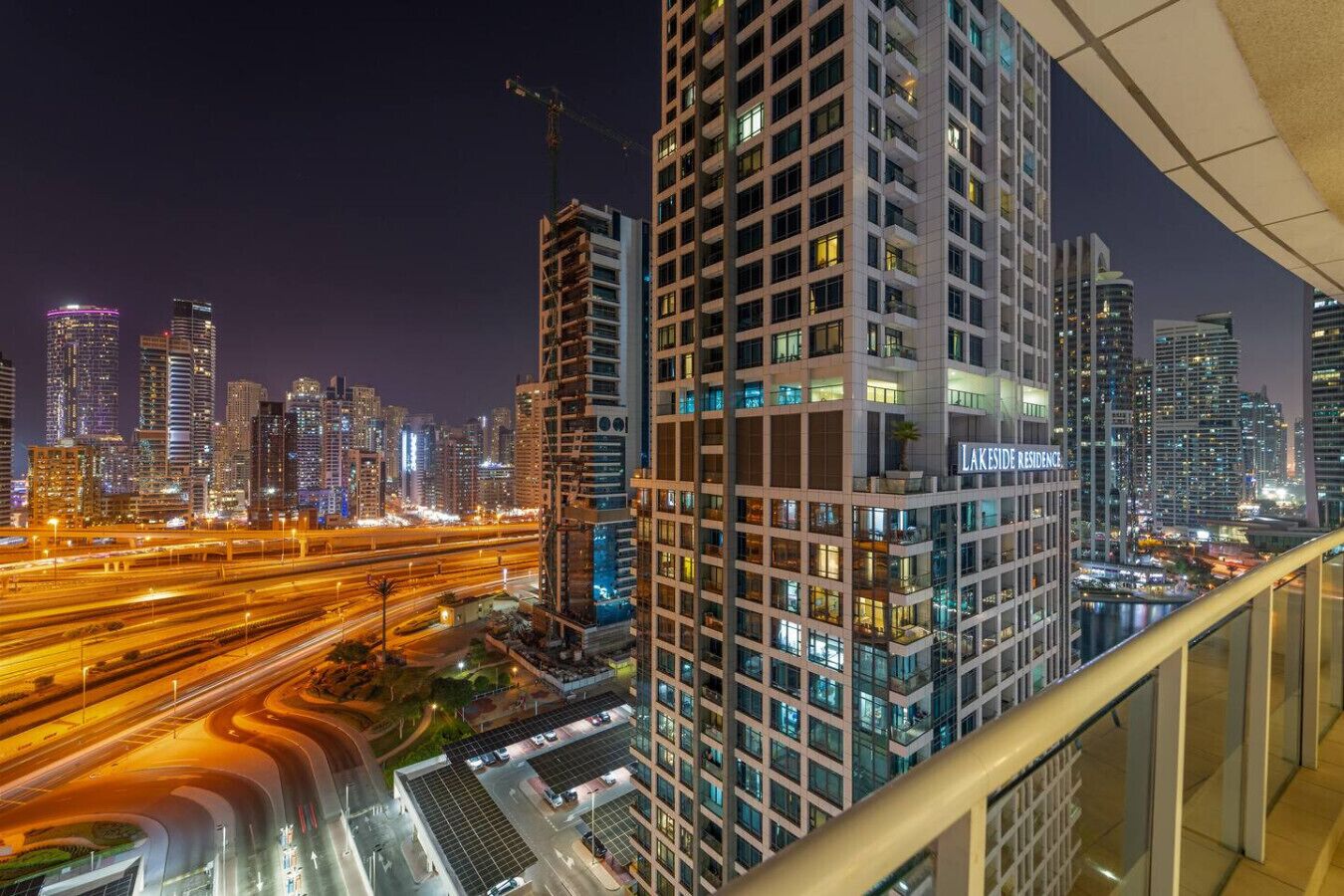 A high-rise building with a modern architectural design, featuring multiple balconies and a prominent signage for Lakeside Residence.