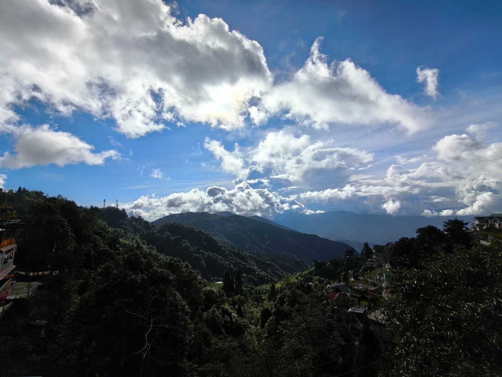 A mountainous landscape with scattered clouds.