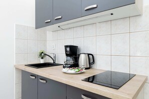 Fridge, microwave, stovetop, coffee/tea maker