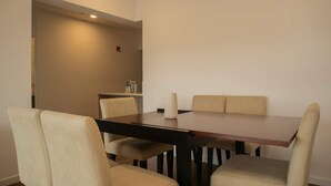 A dining area with a rectangular table, six beige upholstered chairs, and a vase on the table. - w Delightful 2BR w Balcony in Miraflores (Lima)