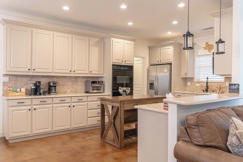 Modern country comfort in this 4-bedroom Anna retreat near McKinney. Sleeps 12 with open layout, full kitchen, foosball, and covered patio with BBQ. Rustic Texas charm with modern amenities — perfect for family or group getaways.