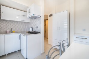 Apartment, Pool View, Garden Area | Private kitchen | Mini-fridge, stovetop, highchair, cookware/dishes/utensils