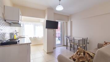 Apartment, City View, Garden Area | Private kitchen | Mini-fridge, stovetop, highchair, cookware/dishes/utensils