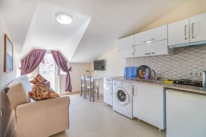 Apartment, Courtyard View, Garden Area | Private kitchen | Mini-fridge, stovetop, highchair, cookware/dishes/utensils