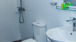 A modern bathroom with a shower, toilet, and sink. - Jade Ella (Ella)