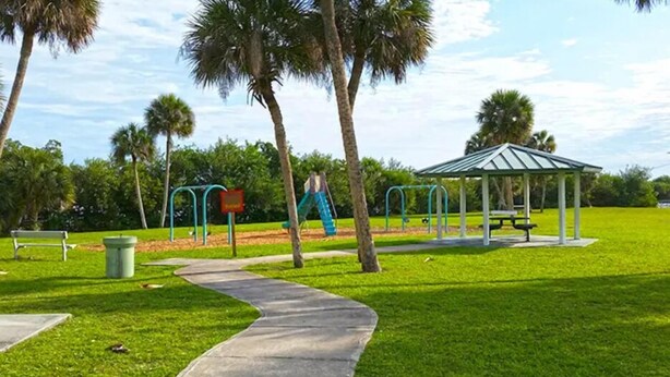 A park with a playground, a gazebo, and a walking path.