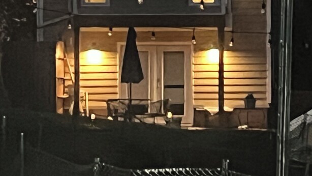 A two-story house with a balcony, a front door, and a small porch area. - The Quiet House on Main Street minutes from Everywhere (Shrewsbury)