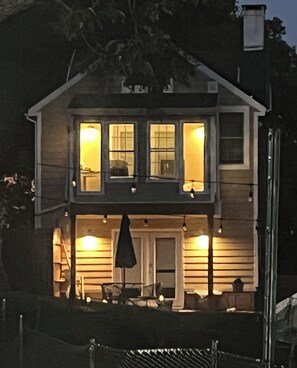 A two-story house with a balcony, a front door, and a small porch area. - The Quiet House on Main Street minutes from Everywhere (Shrewsbury)