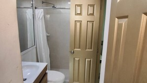 A bathroom with a toilet, sink, and shower. - Cozy 2nd Floor Apartment in Heart of Cartagena (Cartagena)