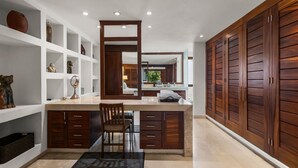 A modern bathroom with a large mirror, wooden cabinets, and a vanity with a sink. - Pelicano. Beachfront 2 floor condo in Bucerias (Bucerías)