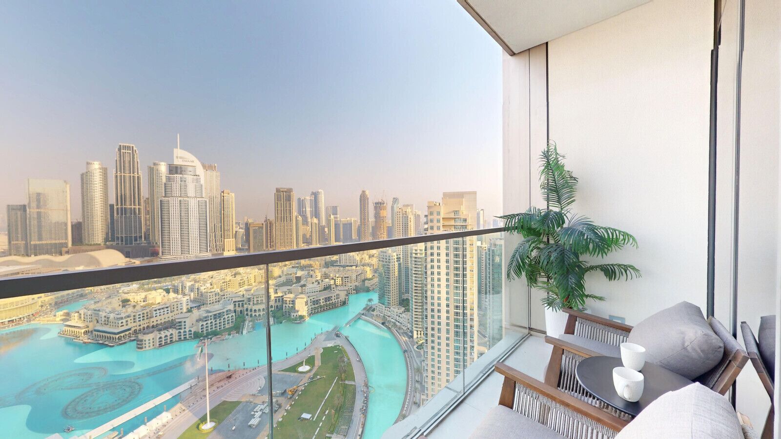 A balcony with a view of a cityscape and a body of water.