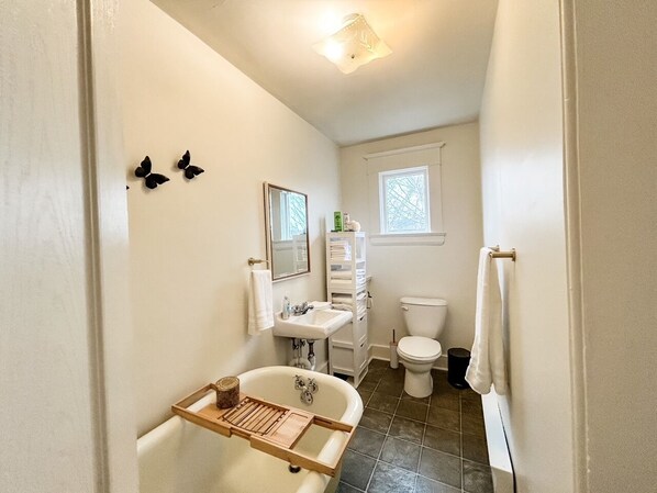 A bathroom with a bathtub, sink, and toilet.