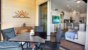 A cozy living area with a dining table, chairs, a fireplace, and a TV in the background.