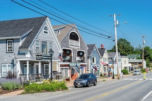 A street view with a two-story building featuring a balcony and a sign for Edward Jones Investments. - Resort style, family friendly getaway! (Lincolnville)