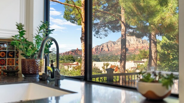 A kitchen with a sink, a window, and a view of a mountainous landscape. - Luxury Desert Retreat w/ Hot tub + Fire Pit! (Sedona)