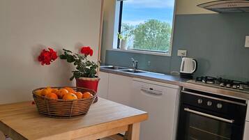 Fridge, oven, toaster, dining tables