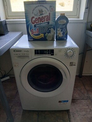 A Candy SmartPro inverter washing machine with a 10kg capacity, a digital control panel, and a 10-year warranty.