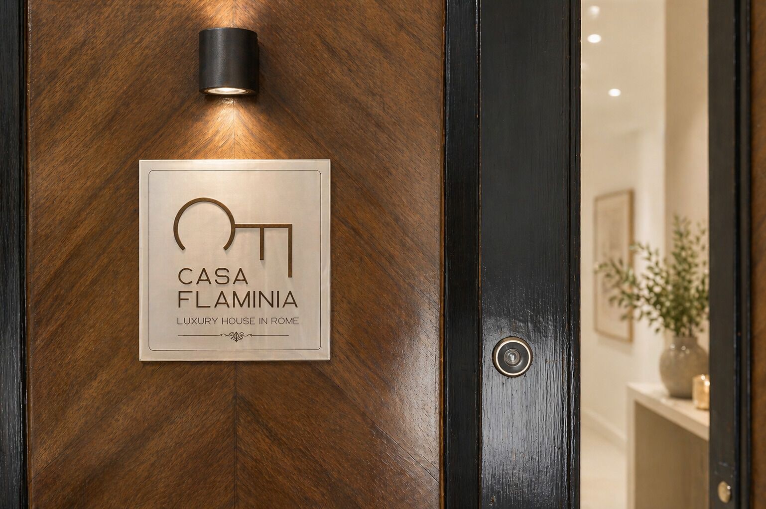A door with a plaque that reads 'CASA FLAMINIA LUXURY HOUSE IN ROME.'