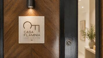 A door with a plaque that reads 'CASA FLAMINIA LUXURY HOUSE IN ROME.'