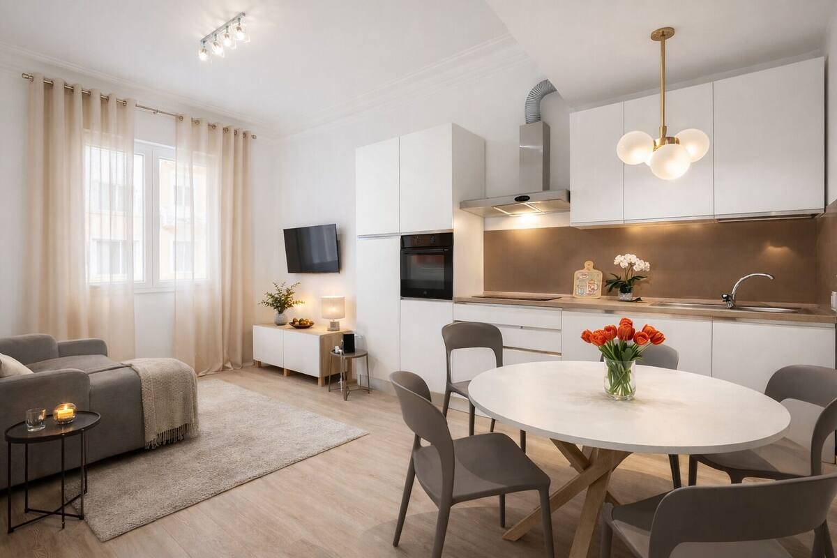 A modern living room with a sofa, a coffee table, and a dining area with chairs and a table.