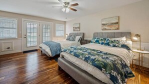 A bedroom with two beds, a ceiling fan, and a nightstand with a lamp. - Charming Downtown Home, Walk to CDA Shops&Eateries (Coeur d'Alene)
