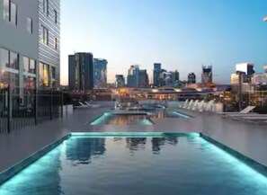 A rooftop pool with a city skyline view.