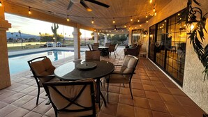 An outdoor patio area with a pool, seating, and a ceiling fan. - THE BEST VIEW! On the Golf Course with Pool! (Lake Havasu City)
