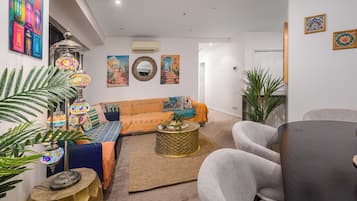 Design Apartment, River View | Living area | 60-inch Smart TV with digital channels, Netflix, streaming services