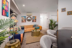 Design Apartment, River View | Living area | 60-inch Smart TV with digital channels, Netflix, streaming services - Arabian Nights-Level 60-Meriton Suites (Brisbane)