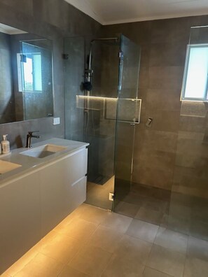Shower, hair dryer, soap, toilet paper