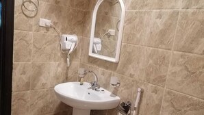 A bathroom with a sink, mirror, and toilet. - fakhamat almasif (Taif)