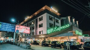A hotel with a sign for 'Sai Palace' and 'UDIPI Express' on the facade. - The Jeevan Inn (Shirdi)