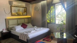 A well-lit bedroom with a bed, bedside table, and a window with curtains. - Sampan Resort (Cox's Bazar)