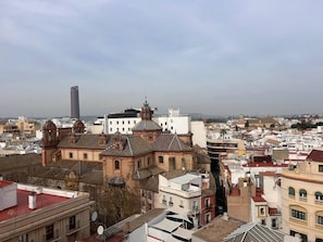 A cityscape with historic buildings and a modern skyscraper.
