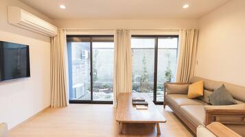 Deluxe Villa, Courtyard View | Living room | 40-inch flat-screen TV with digital channels