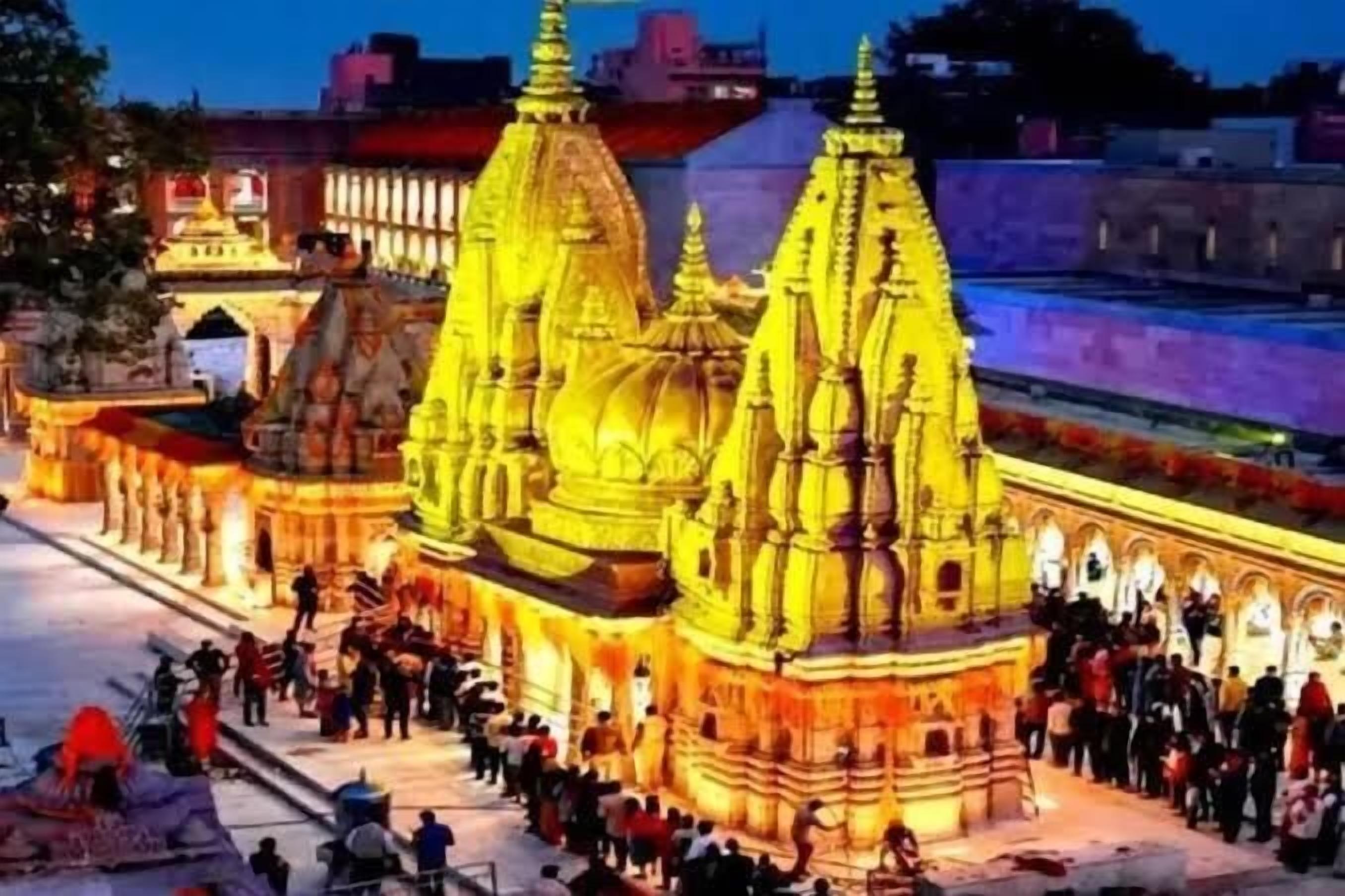 A temple with multiple spires and a crowd of people.