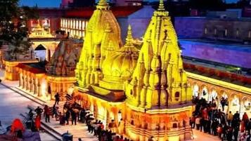 A temple with multiple spires and a crowd of people.