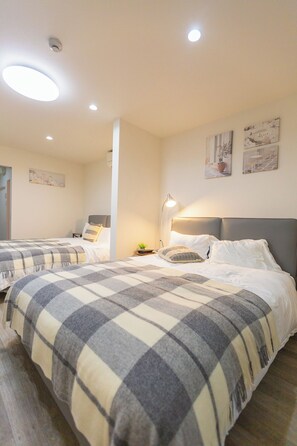 Family Room, Balcony, City View | Blackout drapes, free WiFi