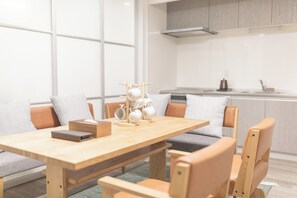 A modern kitchen with a dining area.