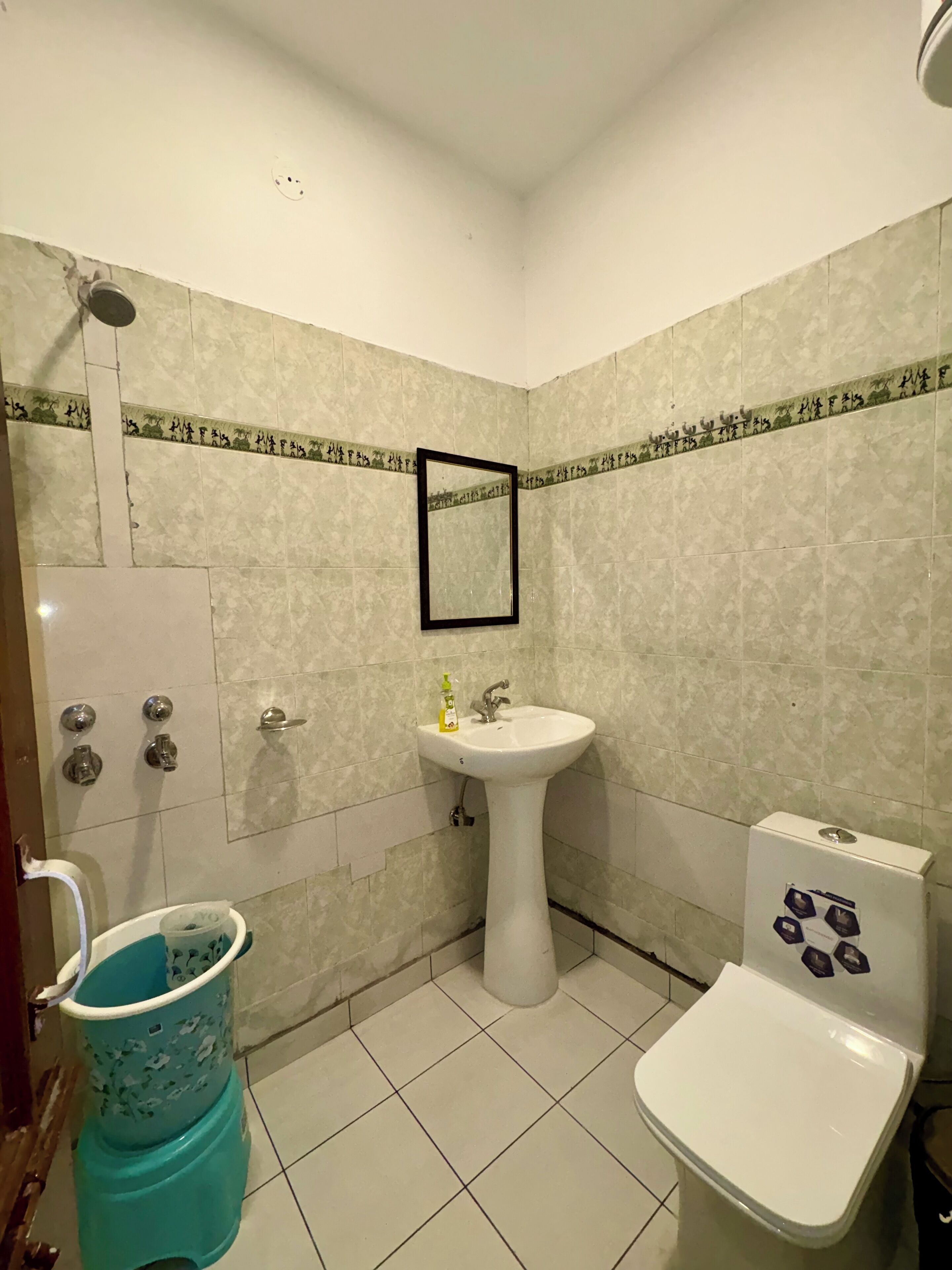 A bathroom with a sink, toilet, and shower.