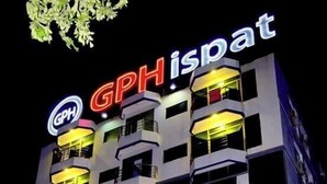 A multi-story hotel with illuminated signage reading "GPH ispat" and "Honeymoon Resorts".