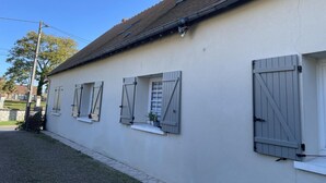A building with a light-colored exterior, a tiled roof, and shutters on the windows. - Stay at the edge of Chambord Park, comfy former lodging close to windmills (Maslives)