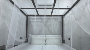 A bed with a canopy and a headboard with a geometric design.