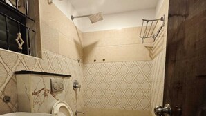 A bathroom with a toilet, sink, and shower. - Stayz Royale Koramangala (Bengaluru)