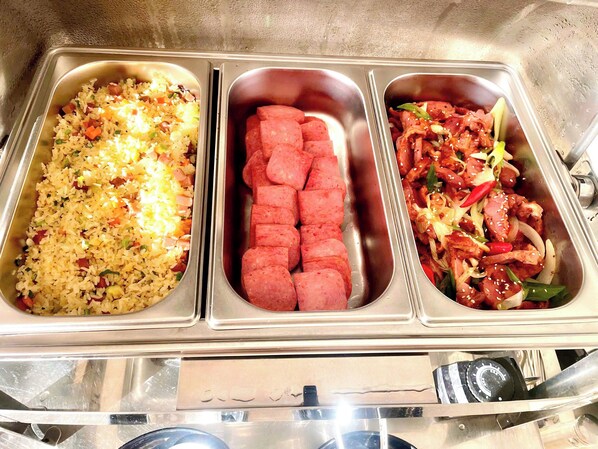 A stainless steel buffet with three compartments containing different dishes. - SKY GARDEN HOTEL (Vo Cuong)