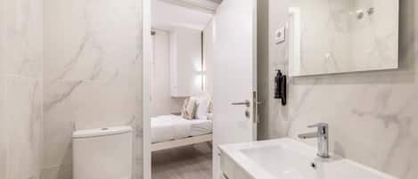 Family Apartment | Bathroom | Rainfall showerhead, hair dryer, towels, soap