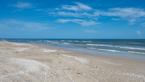 A beach with a clear sky and calm sea. - Mabry 1 Bedroom Home (Port Bolivar)